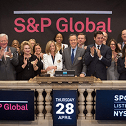 A group of people standing in front of S&P Global sign